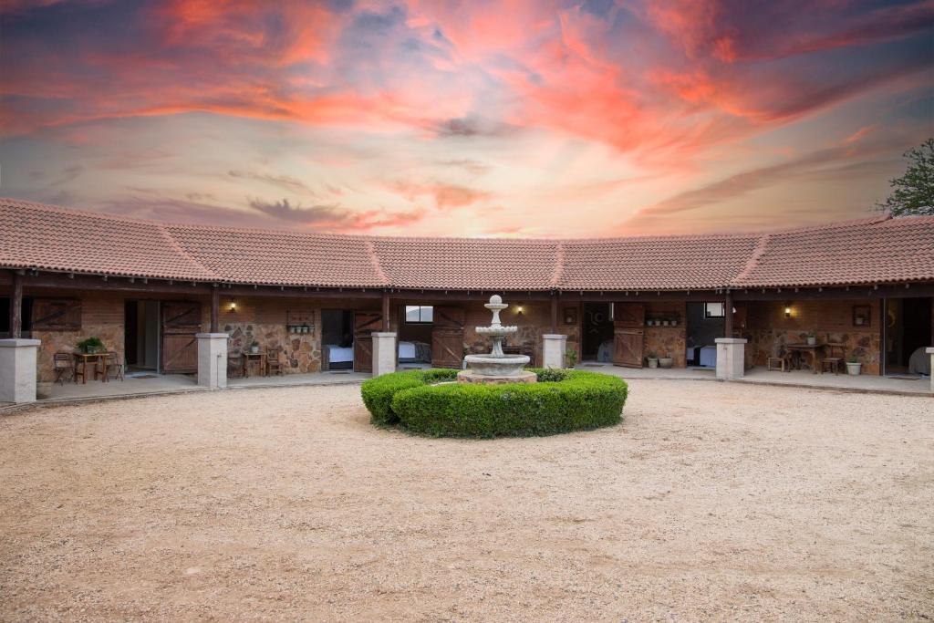 a building with a fountain in front of it at Mount High Luxury Stables in Lydenburg