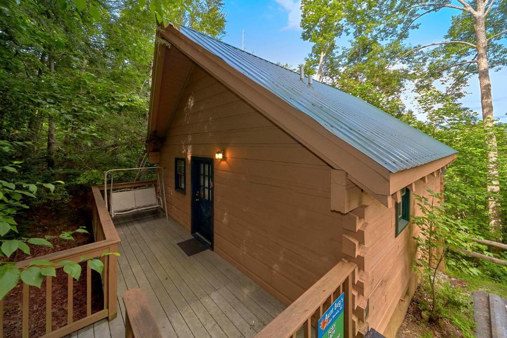 a large wooden cabin with a porch and a deck at Foxy Lady #1531 in Gatlinburg