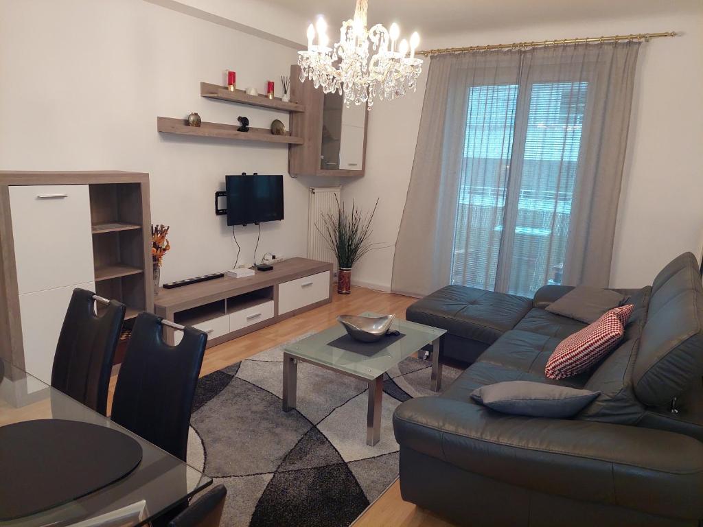 a living room with a couch and a table at 3-rooms apartment for up to 4 persons near to Prater in Vienna