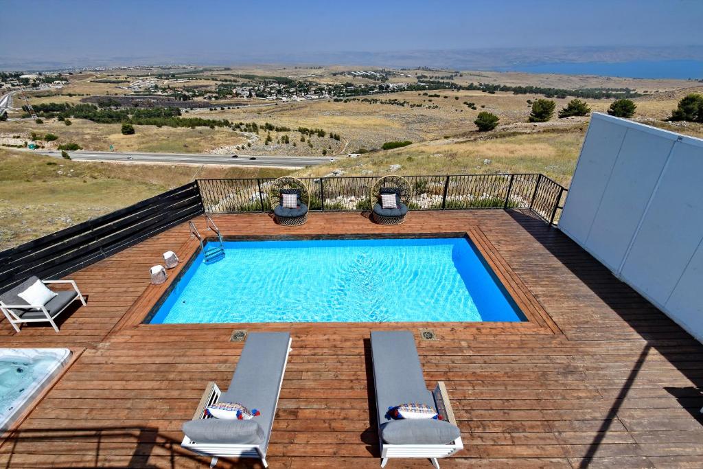 a swimming pool on top of a wooden deck at Villa Troya in Safed