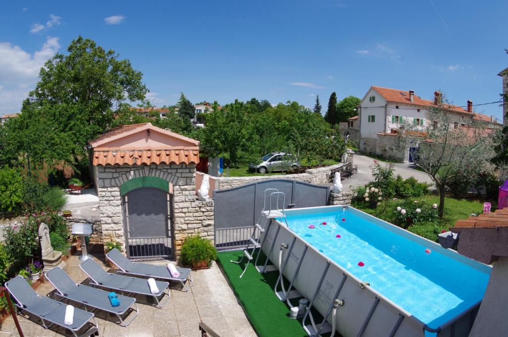 an outdoor swimming pool with lounge chairs and a swimming pool at Apartment Elena, village Peresiji in Peresiji