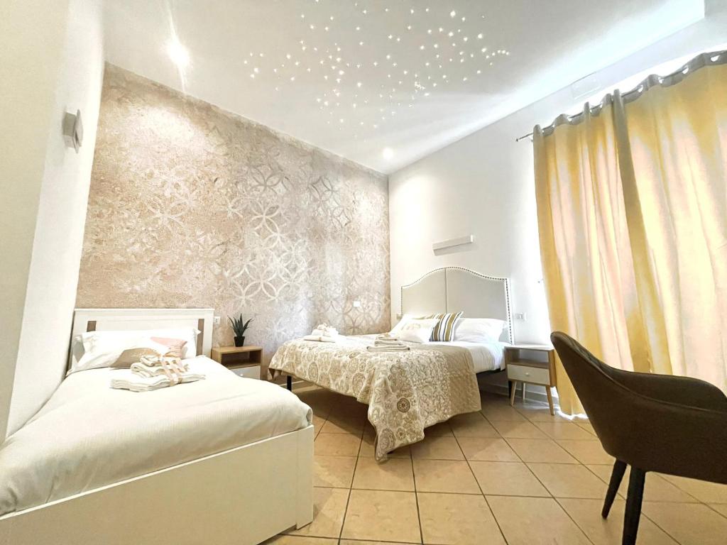 a bedroom with two beds and a wall with stars at BARI ROOMS Abate Gimma in Bari