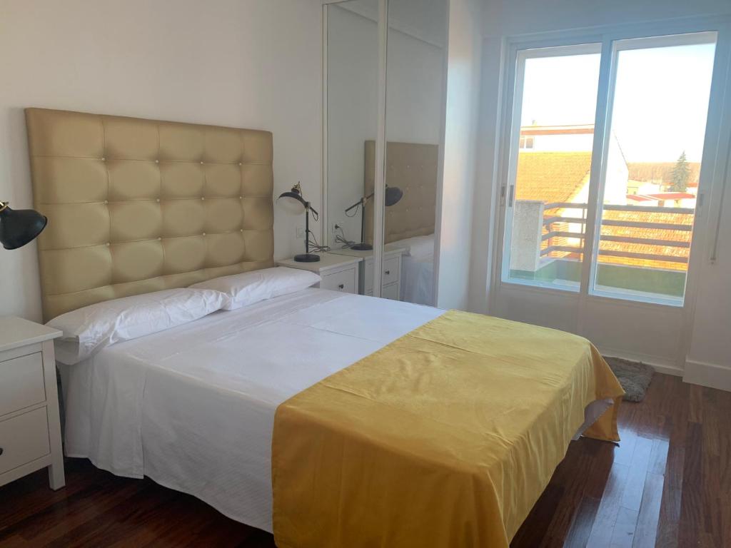 um quarto com uma cama grande e uma janela em Villa Aurora em La Bañeza