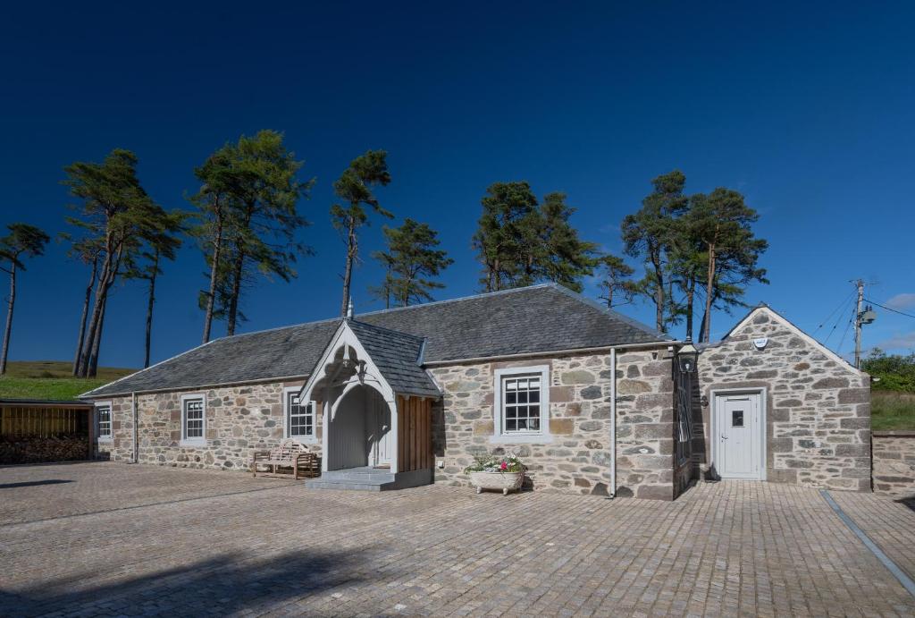 a stone church with a driveway in front of it at Stables Cottage in Perth