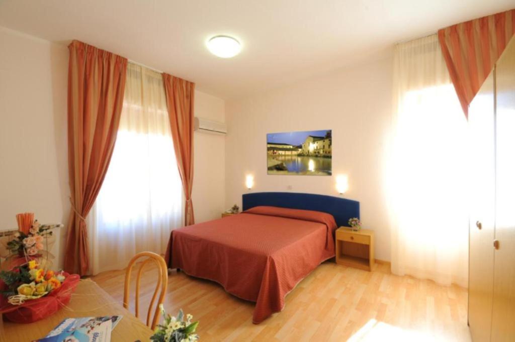 Postel nebo postele na pokoji v ubytování Hotel Perugina