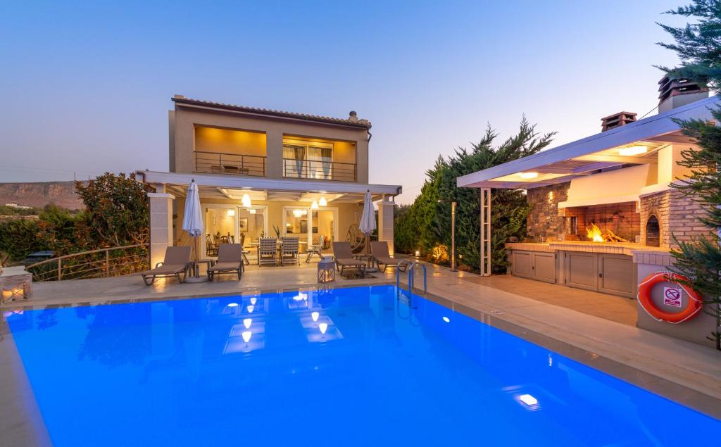 a large swimming pool in front of a house at Villa Penelope in Gouves