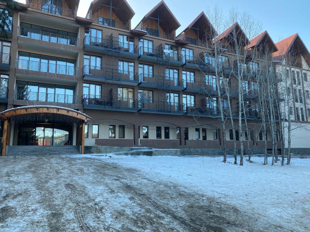 a large building with snow in front of it at *Bakuriani Resort* Cozy & Comfortable Apt. in Bakuriani