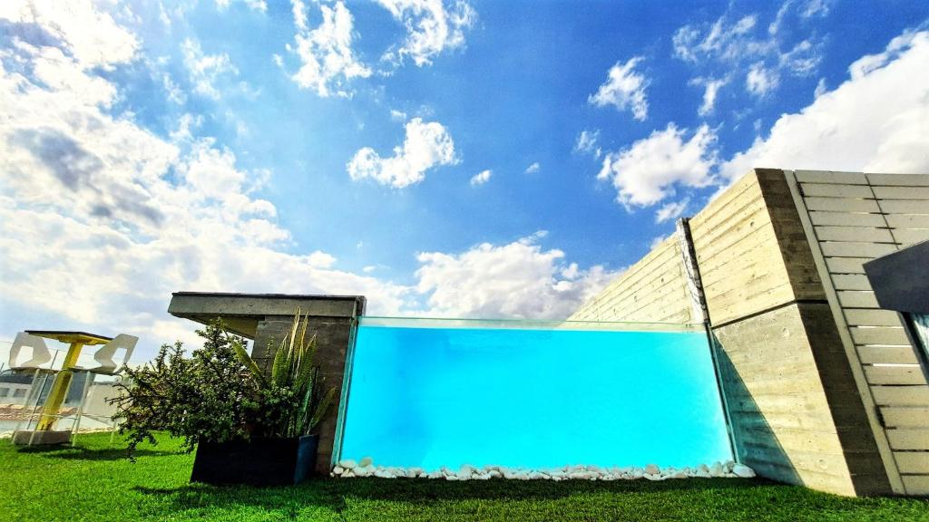 un bâtiment avec une piscine bleue à côté d'un bâtiment dans l'établissement Lokàl Boutique Hotel, à Larnaka