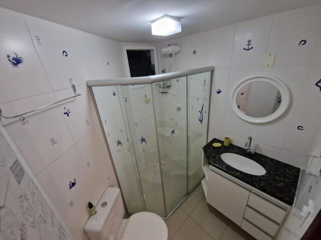a bathroom with a shower and a toilet and a sink at Apt - Orla de Maceio in Maceió