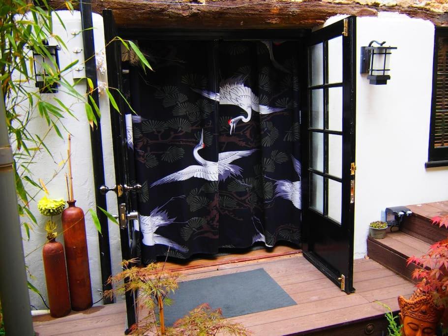 a black and white door with white birds on it at Unique space in heart of Frome in Frome