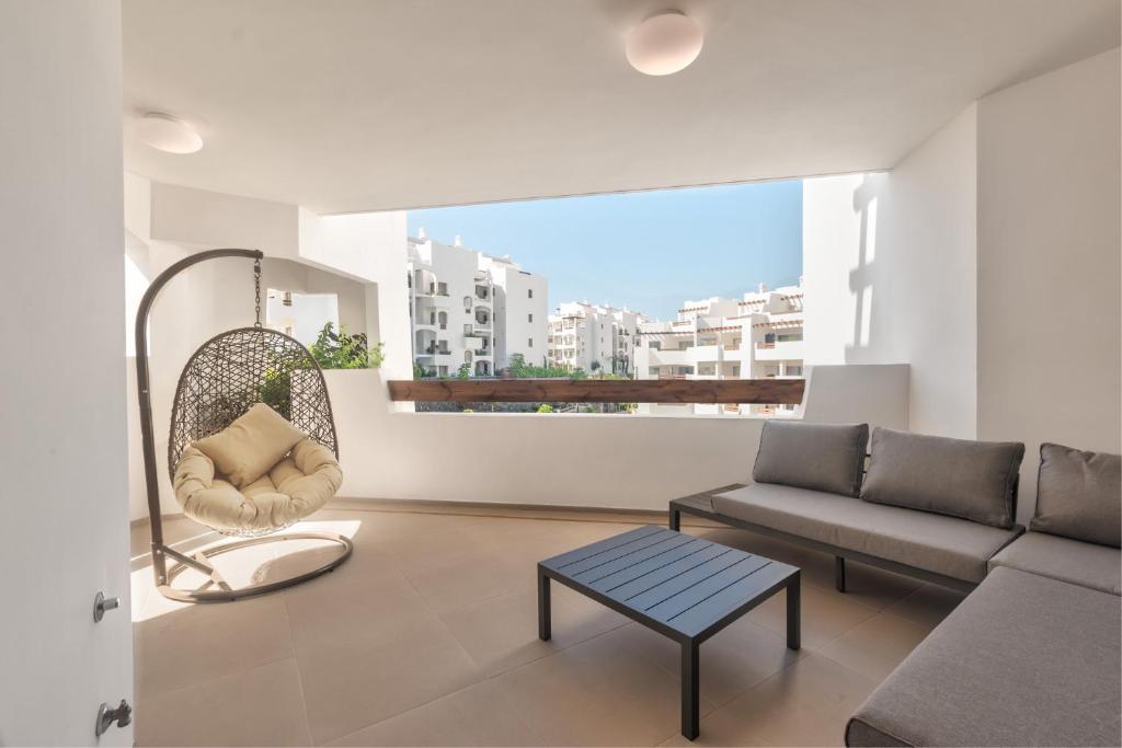 a living room with a couch and a chair at Jardines - Tabor 2 1 POOL VIEW 2B in Palm-Mar
