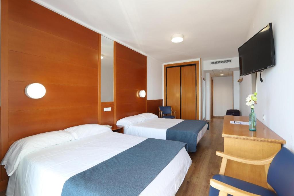 Кровать или кровати в номере Hotel Poseidon Playa