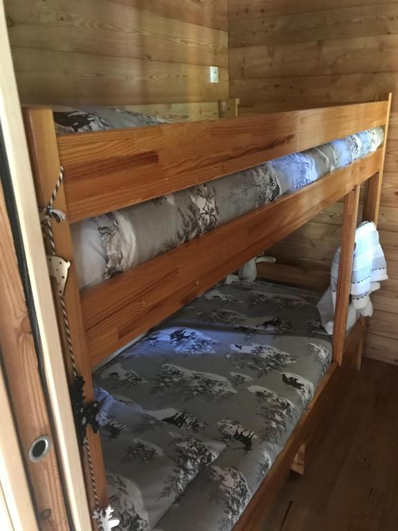 a couple of bunk beds in a room at Ambiance petit chalet in La Salle Les Alpes
