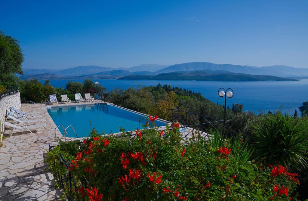 a swimming pool with a view of a lake at Villa Vasso Sea View Residences in Agnítsini