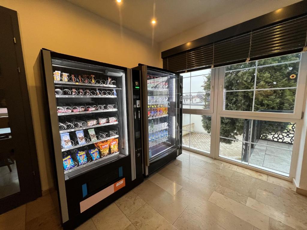 a room with a refrigerator with drinks in it at F Hotel in Hörsching