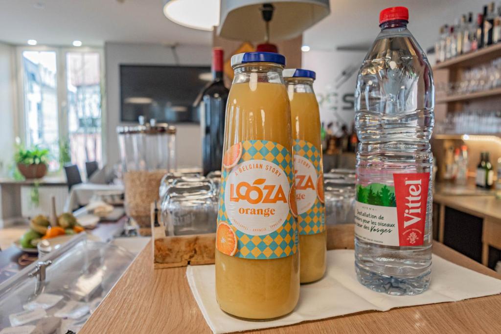 two bottles of orange juice sitting on a counter at Hotel Herckmans in Ettelbruck
