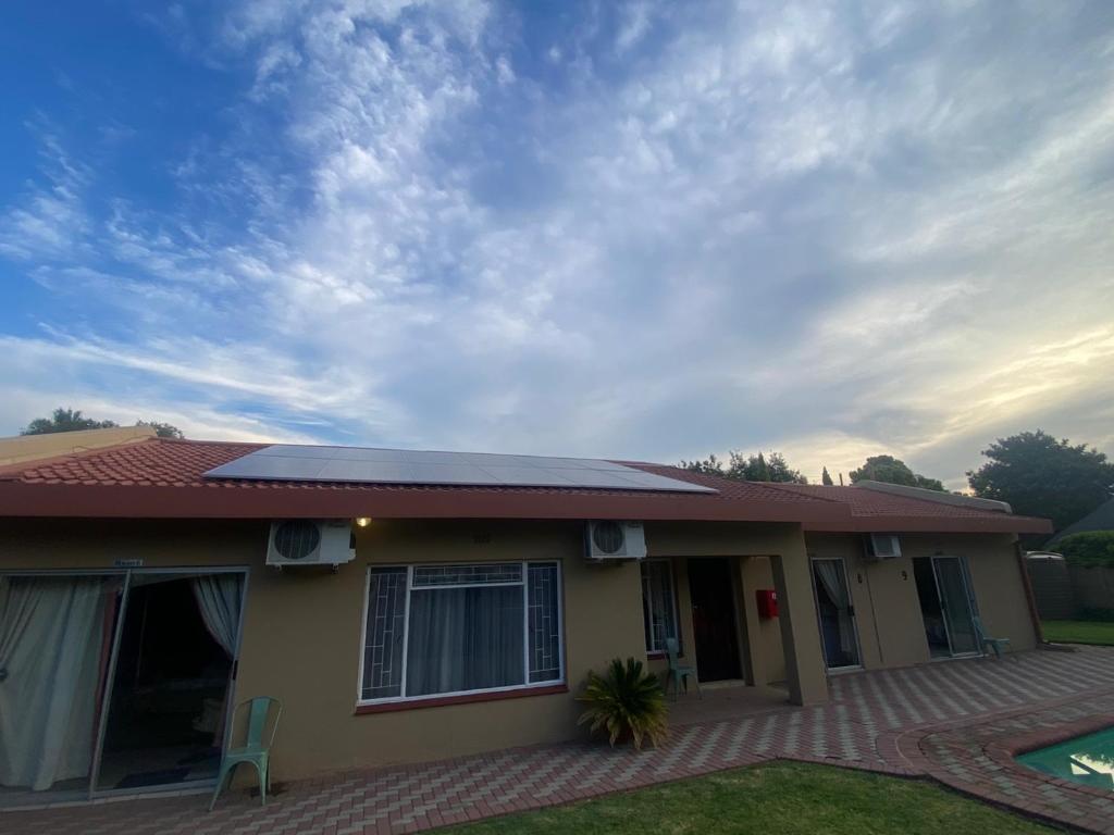 a house with a solar panel on the roof at Jolani 2 Guest House in Welkom