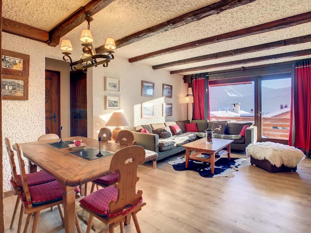 a living room with a table and a couch at Porthos 29-30 in Verbier