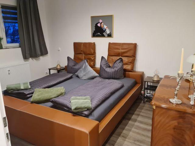 two beds in a room with two chairs at Pilgrims "Rosalie" große Fewo mit 3 Schlafzimmern, 1Bad, 2 WC, Balkon, fast Internet in Brilon