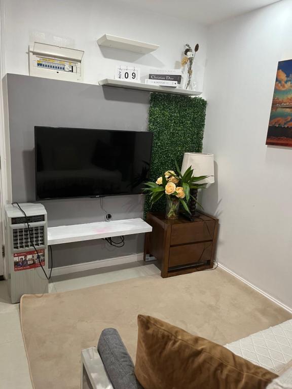 een woonkamer met een flatscreen-tv en een bank bij 2br condo unit Azure Residences by Ms. M in Manilla