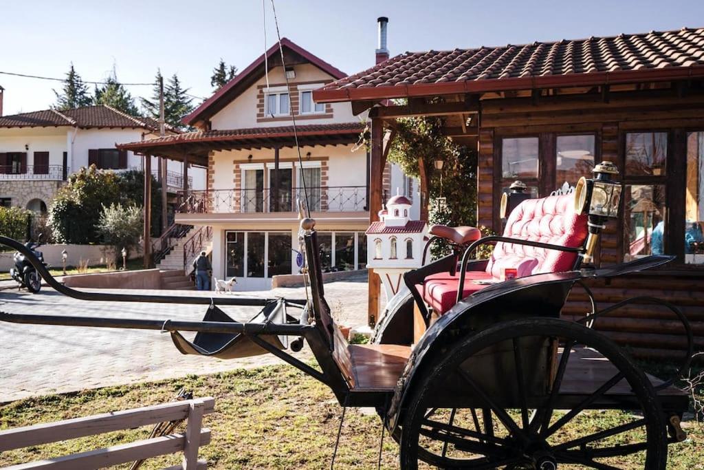 a horse drawn carriage in front of a house at Ολοκληρη Βιλα in Edessa
