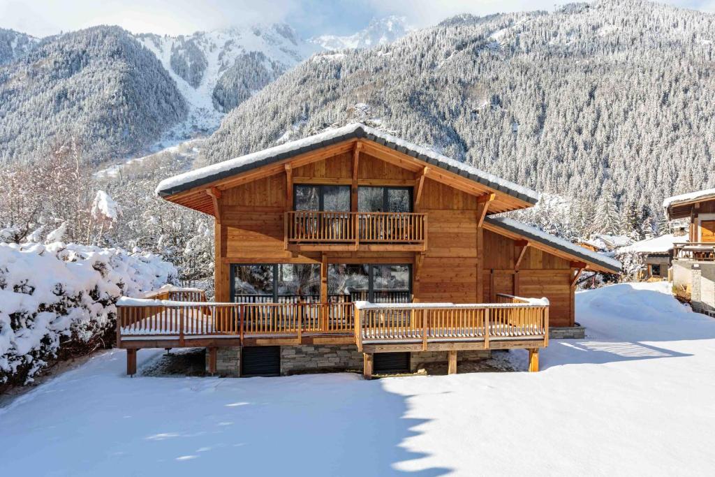 ein Blockhaus mit Balkon im Schnee in der Unterkunft Chalet du Gouter - Chamonix All Year in Chamonix-Mont-Blanc