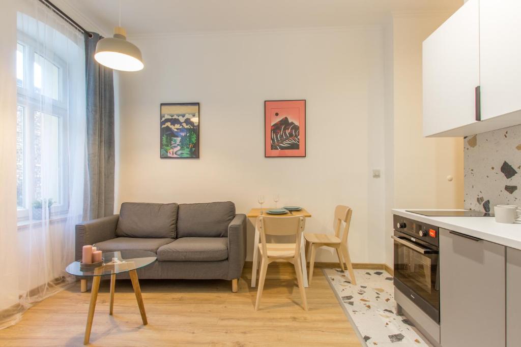 a living room with a couch and a table at Golden Apartments/SobF in Katowice
