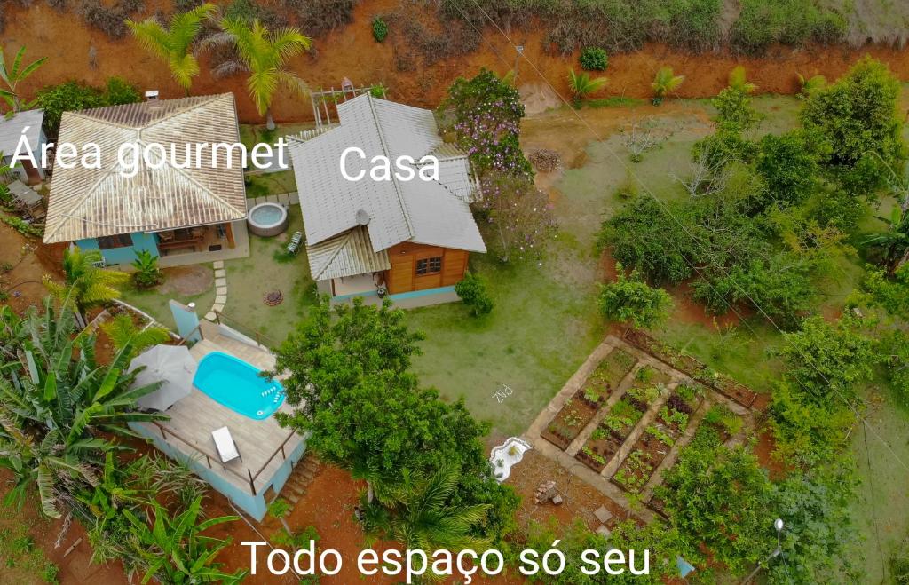 an aerial view of a house with a pool at Chalé Vista da Mata DM, 5km Centro Domingos Martins, Wi Fi, fibra óptica, SPA aquecido, split, privacidade, aceita pets in Domingos Martins