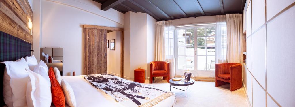 a hotel room with a bed and a window at Hotel Le Chabichou in Courchevel