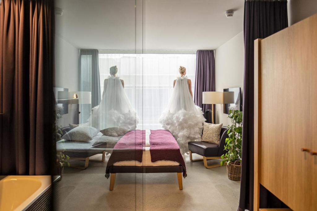 a room with a wedding dress hanging in a window at Nomad Design & Lifestyle Hotel in Basel
