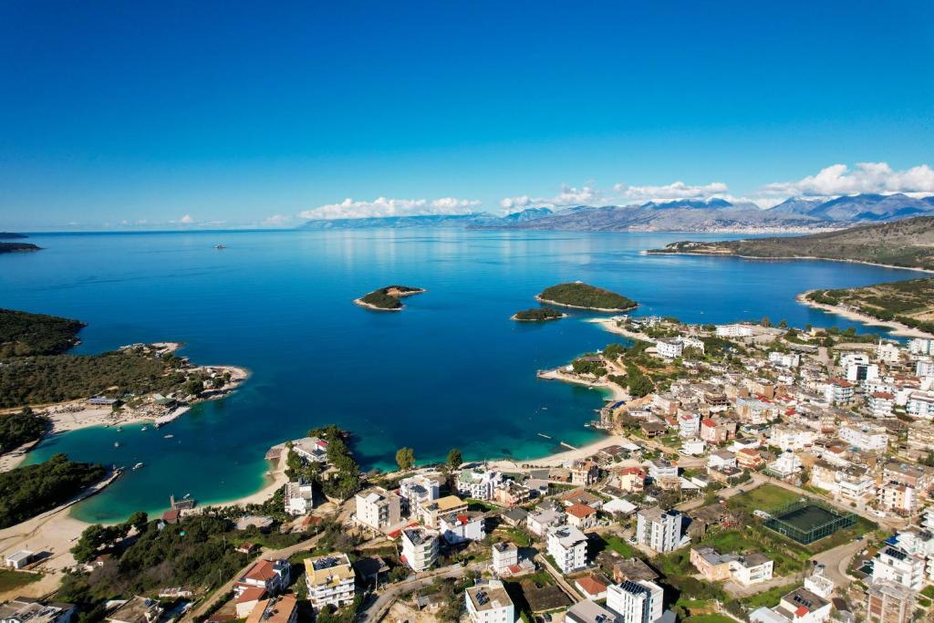 an aerial view of a town on the shore of a lake at Guest House Gerard in Ksamil
