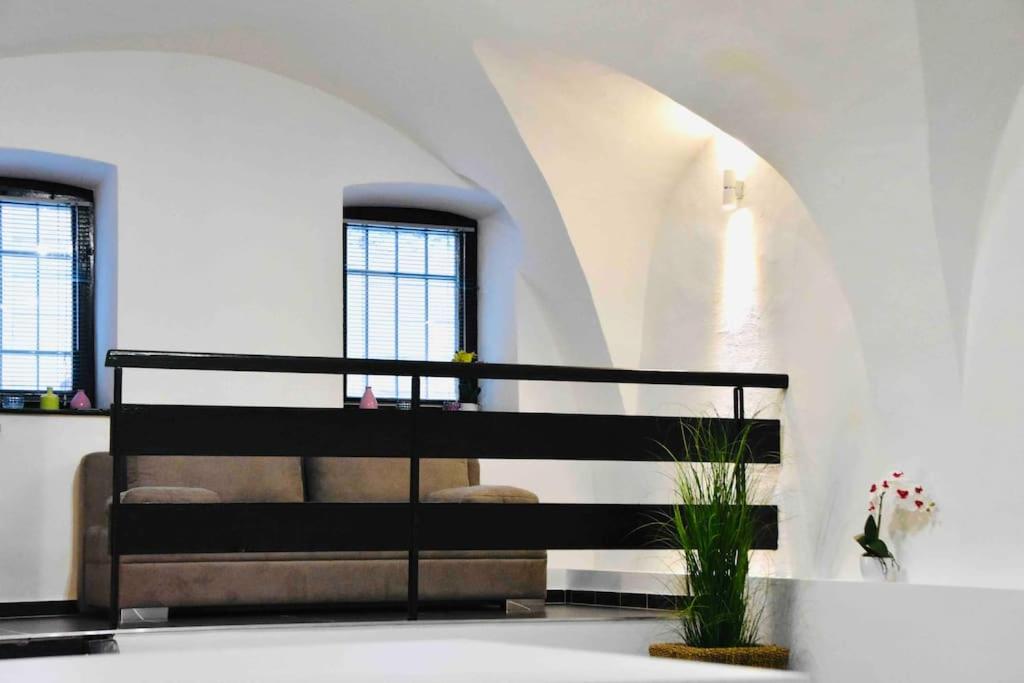 a room with a staircase with a bench and a plant at Nuovo Casa in Sopron