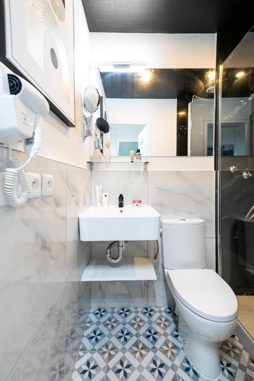a bathroom with a white toilet and a sink at Apartments WS Tour Eiffel - Laos in Paris
