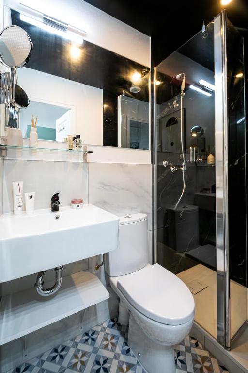 a bathroom with a toilet and a sink and a shower at Apartments WS Tour Eiffel - Laos in Paris