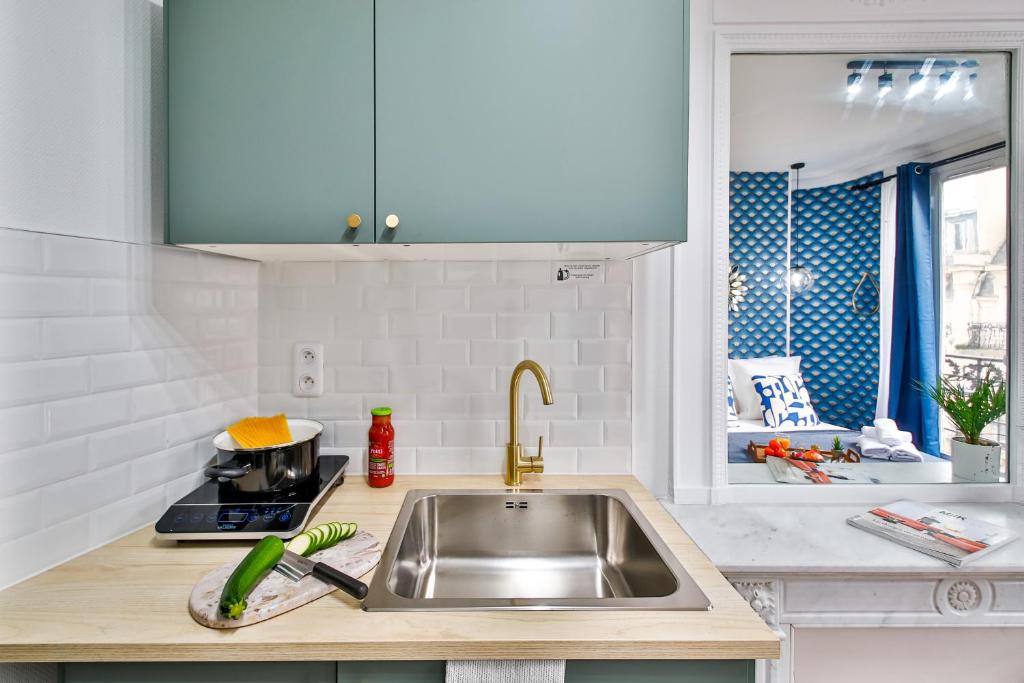 a kitchen with a sink and a counter top at Apartments WS Tour Eiffel - Laos in Paris