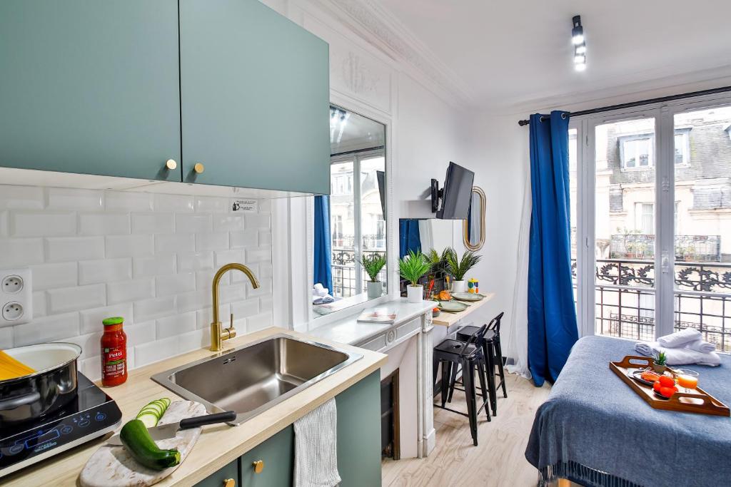 a kitchen with a sink and a counter top at Apartments WS Tour Eiffel - Laos in Paris
