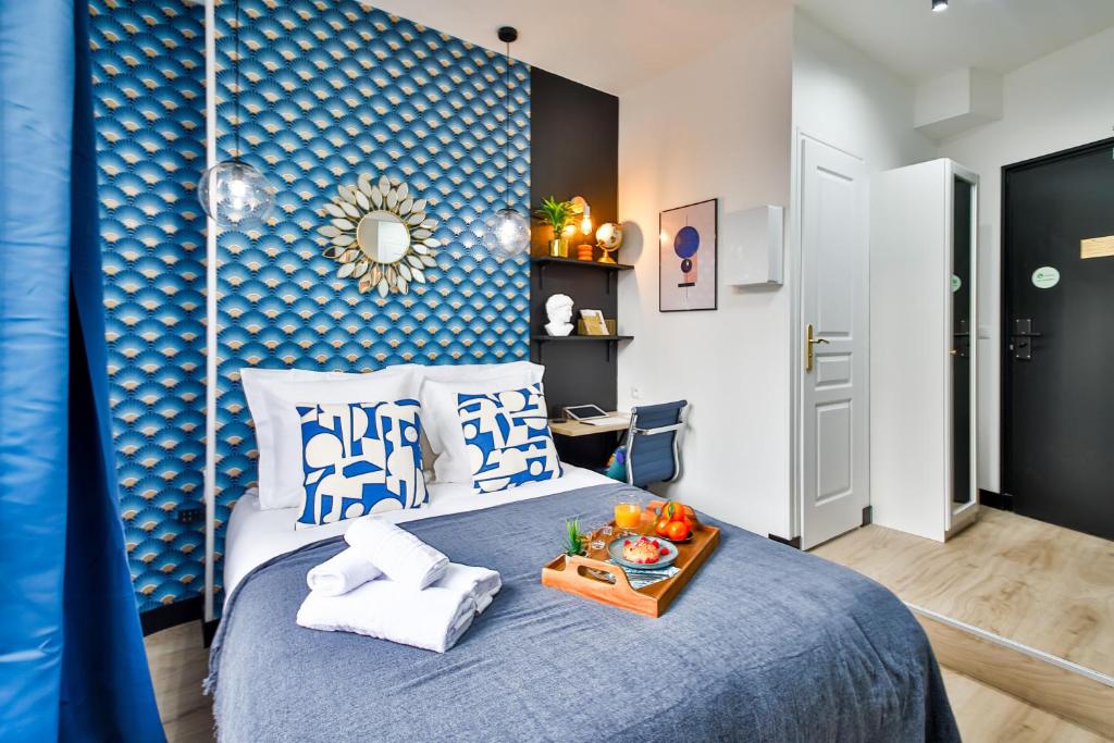 a bedroom with a bed with a blue wall at Apartments WS Tour Eiffel - Laos in Paris