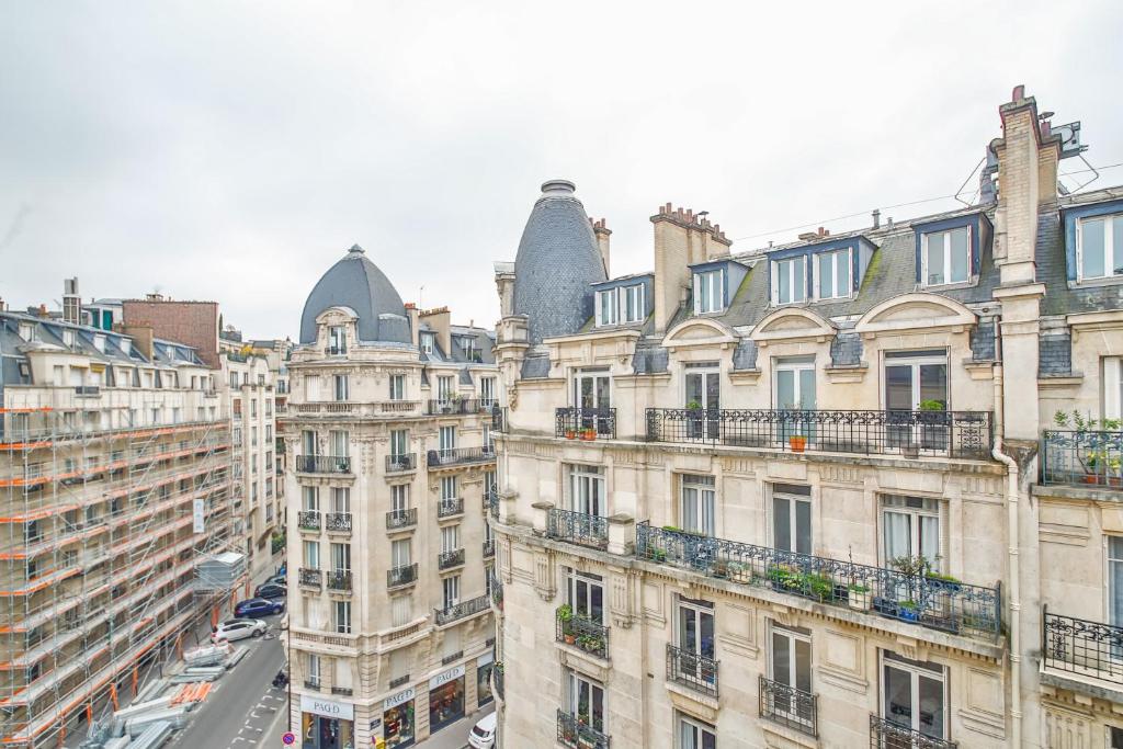 a view of the roofs of buildings in paris at Apartments WS Tour Eiffel - Laos in Paris