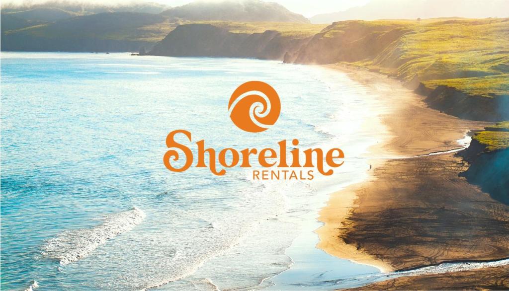 a logo forshoreline rentals on a beach at THE SHORELINE- Beach Access, Ocean Views, Private in Kodiak