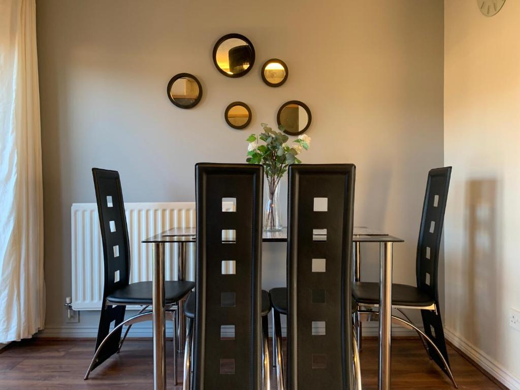 a dining room with a table and chairs and mirrors at House - 10min to City Centre - Sleeps 4 - Parking in Birmingham
