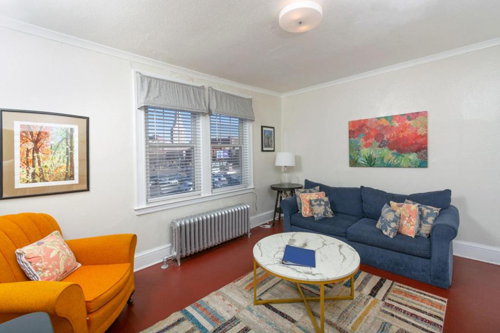 a living room with a blue couch and a table at The Jazz Suite B1 in Hartford