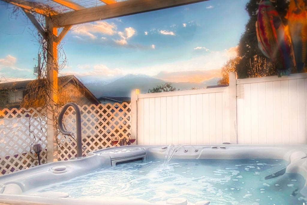 a jacuzzi tub with a view of the mountains at The Victorian Spa Retreat in Port Angeles