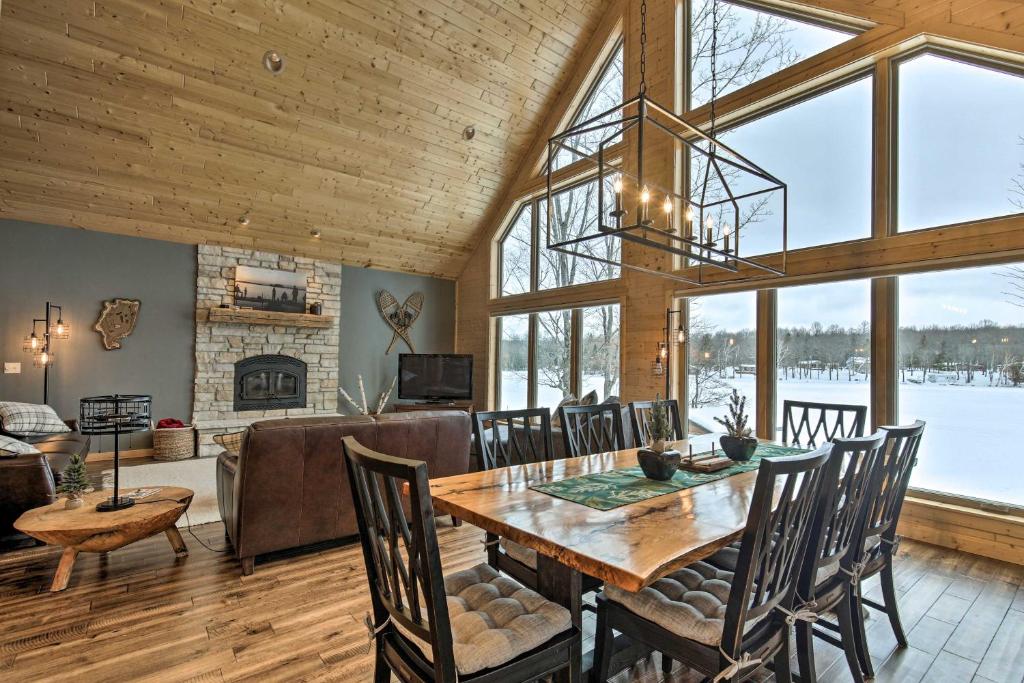 a dining room and living room with a table and chairs at Lakefront Cottage in Iron River with 2 Porches! in Iron River