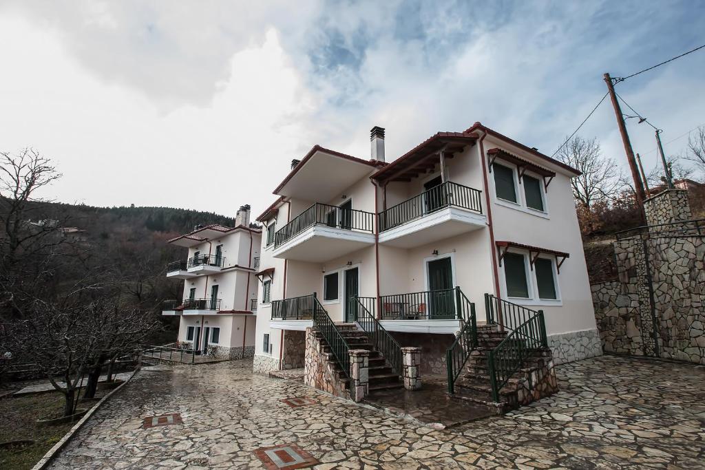 a large white house with stairs on it at Nefeles in Neochori