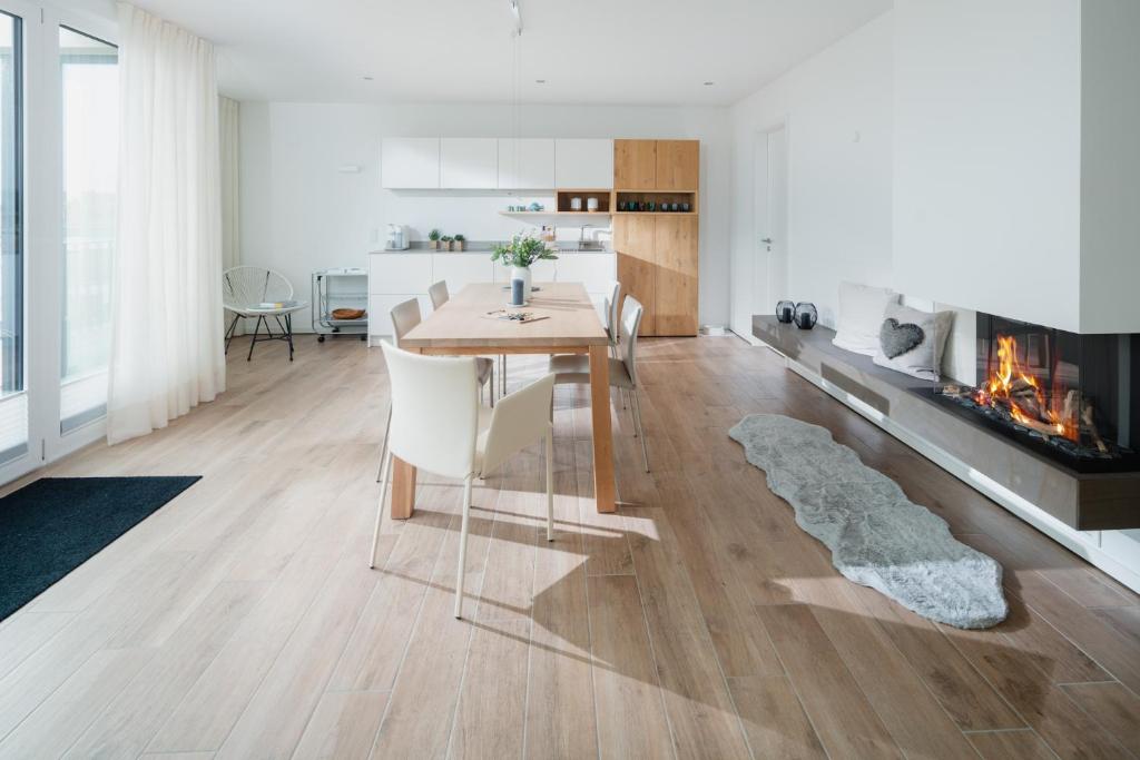 a living room with a table and a fireplace at Penthouse NorderNice in Norderney