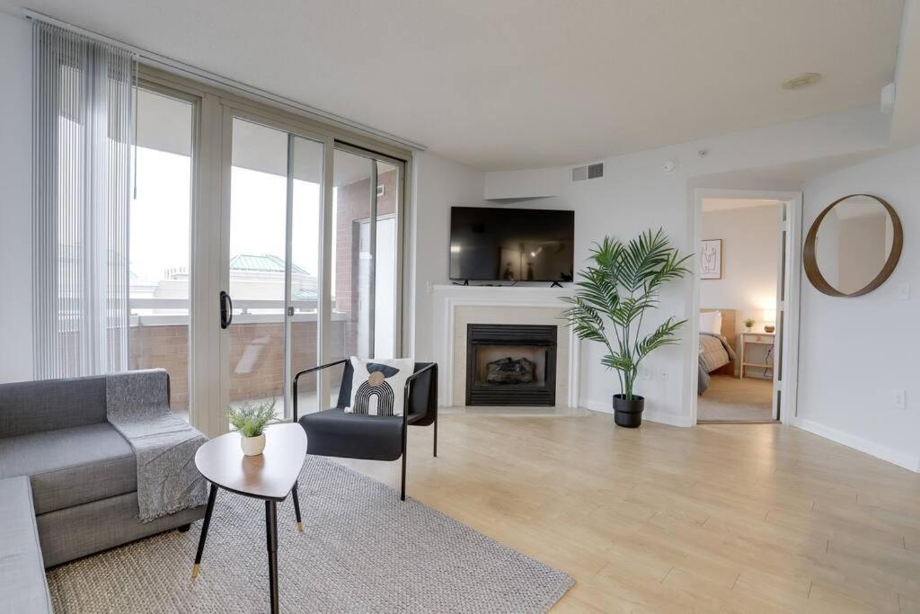 a living room with a couch and a fireplace at Spectacular Condo 2/2 @Ballston With Gym in Arlington