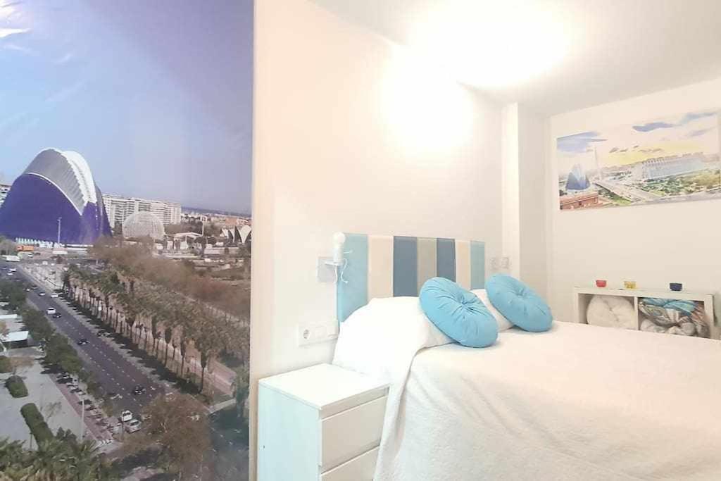 a bedroom with a bed with a view of a city at Vivienda Turistica Valencia 2 in Valencia