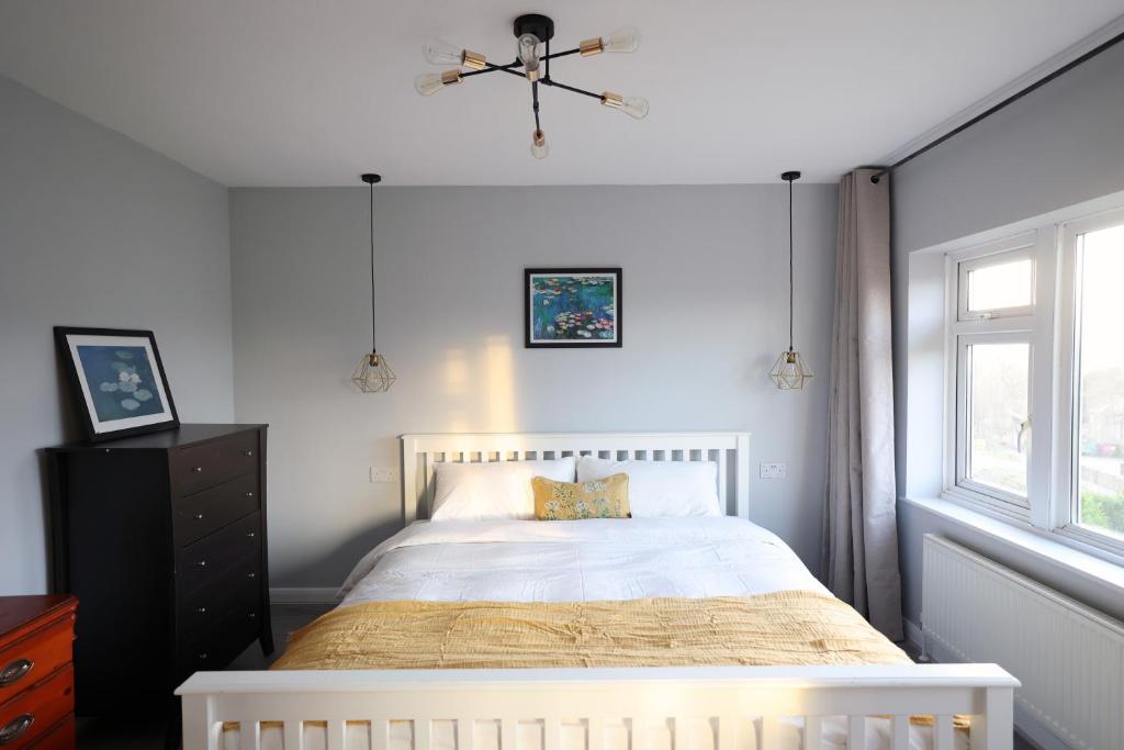 a bedroom with a white bed and a window at Bath City Skyline Spacious 3 Bed House for family in Bath