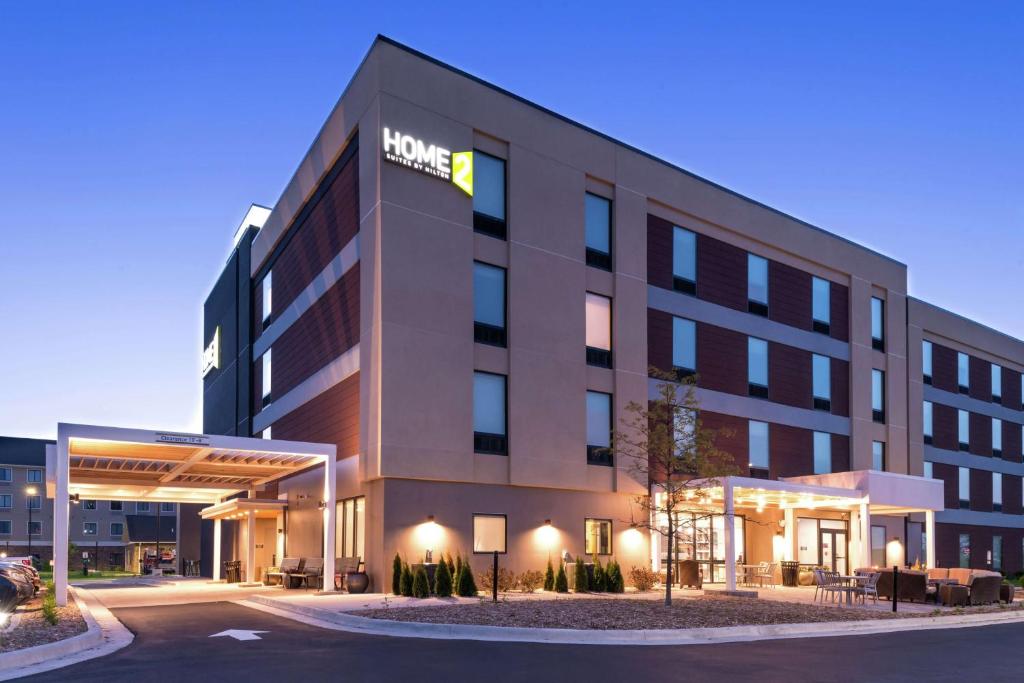 a hotel building with a sign on the front of it at Home2 Suites By Hilton Merrillville in Merrillville