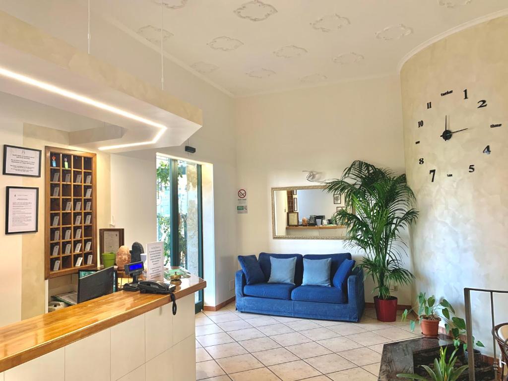 a living room with a blue couch in a room at Hotel Serena in Rieti